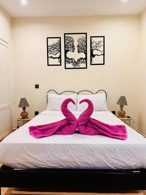 two pink snakes laying on top of a bed at Résidence Miramas 2 E1 in Marrakech