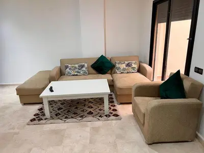 a living room with two couches and a coffee table at Résidence Miramas 2 E1 in Marrakech
