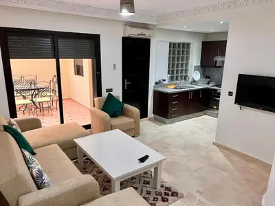 a living room with a couch and a table at Résidence Miramas 2 E1 in Marrakech