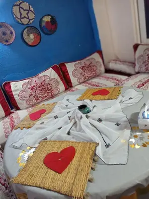 a bed with a white shirt with hearts on it at Riad Derb El Aarsa in Marrakech
