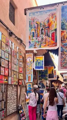 a group of people walking around a store in a market at Riad Derb El Aarsa in Marrakech