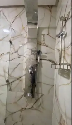 a shower with a glass door in a bathroom at Charming Two-Bedroom Apartment in Gueliz,Marrakesh in Marrakech