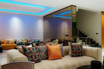 a living room with a couch with colorful pillows at Villa de luxe Avec piscine à Argan Golf Resort in Marrakech