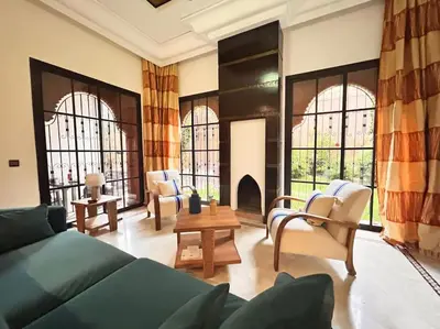 a living room with a couch and chairs and a fireplace at Villa Gioia et Luna Garden City-Services All-inConciergerie in Marrakech