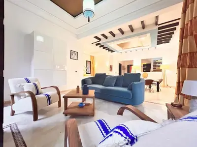 a living room with a blue couch and chairs at Villa Gioia et Luna Garden City-Services All-inConciergerie in Marrakech