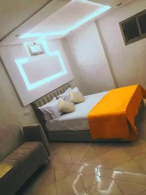 a bedroom with a bed and a couch in a room at Dar yahya in Marrakech