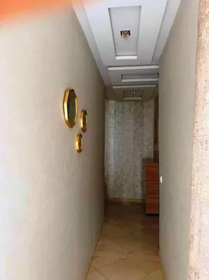 a hallway with a wall with two mirrors on it at Dar yahya in Marrakech