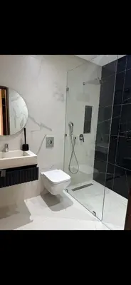 a bathroom with a shower and a toilet and a sink at Luxe villa in marrakech in El Makina