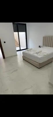 a bedroom with a bed and a large window at Luxe villa in marrakech in El Makina