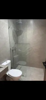 a bathroom with a toilet and a glass shower at Luxe villa in marrakech in El Makina
