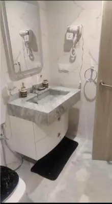 a white bathroom with a sink and a mirror at Elégant duplex au coeur de Marrakech, Nakhil in Marrakech
