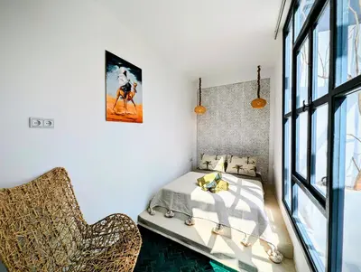 a bedroom with a bed and a window at Riad LISA 6 personnes in Marrakech