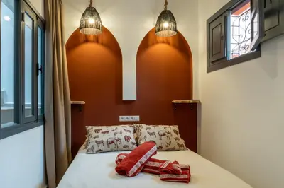 a bedroom with a bed with two pillows on it at Riad LISA 6 personnes in Marrakech