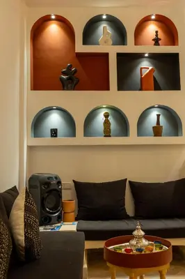 a living room with a couch and a table at Riad LISA 6 personnes in Marrakech