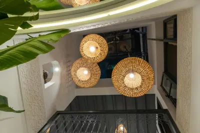 a group of lights hanging from a ceiling at Riad LISA 6 personnes in Marrakech