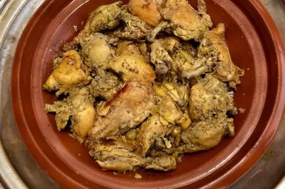 a brown bowl of food on a table at DAR SMAWAR top piscine chauffée 15mn centre ville in El Caïd Omar