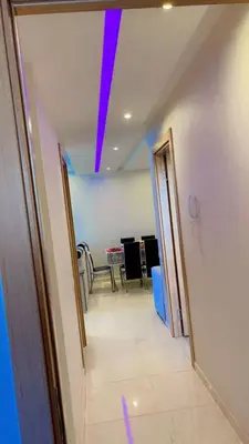 a hallway with a dining room with a purple ceiling at Magnifique appartement coralia in Marrakech