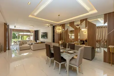 a dining room and living room with a table and chairs at Villa Golf Marrakech in Marrakech