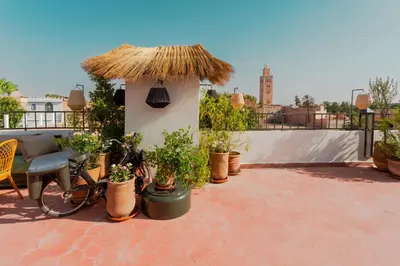 a bike parked on a patio with potted plants at Riad Tawja in Marrakech