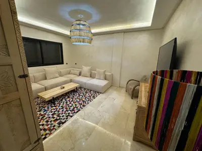 a living room with a couch and a table at Luxury Apartment Hivernage Marrakech in Marrakech