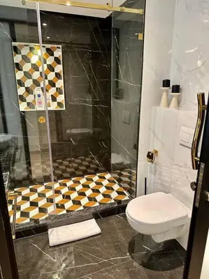 a bathroom with a shower and a toilet at Ultra-Luxury 2-Bedroom Apartment in City Center Atlas View in Marrakech