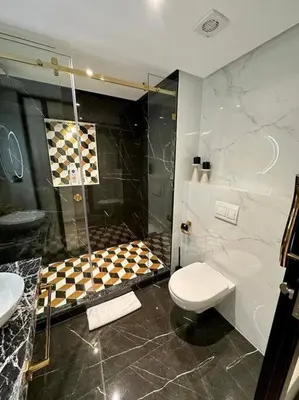 a bathroom with a shower and a toilet and a sink at Ultra-Luxury 2-Bedroom Apartment in City Center Atlas View in Marrakech