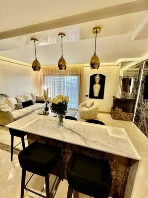 a living room with a table and two chairs at Ultra-Luxury 2-Bedroom Apartment in City Center Atlas View in Marrakech