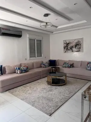a living room with a couch and a table at Appart à Marrakech,spacieux, calme et propre in Marrakech