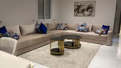 a living room with a couch and a table at Appart à Marrakech,spacieux, calme et propre in Marrakech