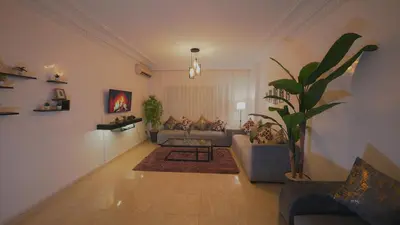 a living room with a couch and a plant at Modern Apartment in Centre of Marrakech For Friends & Families in Marrakech