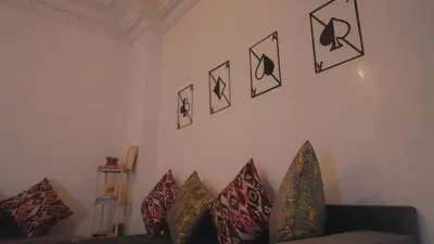 a living room with a couch and pillows on the wall at Modern Apartment in Centre of Marrakech For Friends & Families in Marrakech
