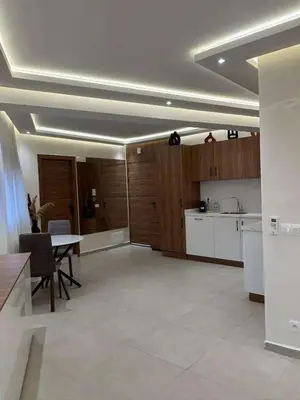 a kitchen and dining room with a table in it at Bel Appartement Hivernage Gueliz in Marrakech