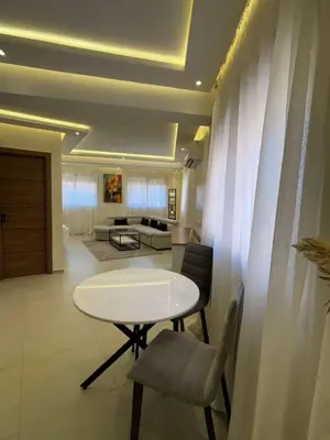 a living room with a white table and chairs at Bel Appartement Hivernage Gueliz in Marrakech