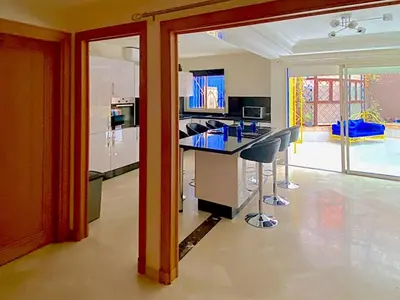 a kitchen with a table and chairs in a room at Yasmine Majorelle Marrakech in Marrakech