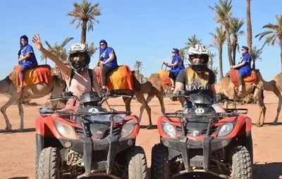 a group of people on atvs and camels in the desert at quad marrakech in Dar Caïd Layadi
