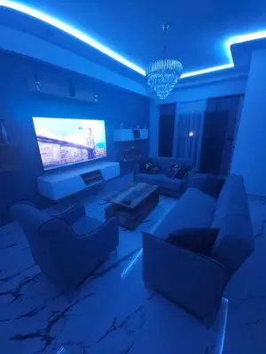a living room with a couch and a tv at Apparemment chic in Marrakech