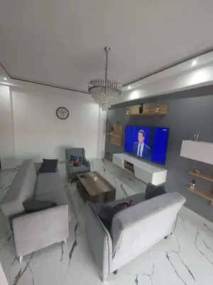a living room with couches and a flat screen tv at Apparemment chic in Marrakech
