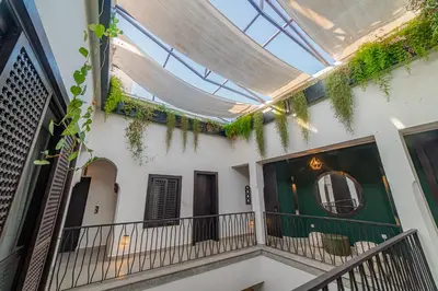arium of a building with a balcony with a mirror at Riad Sabrawa in Marrakech
