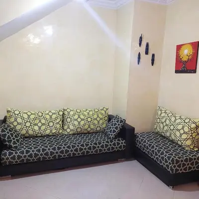 a living room with a couch in the corner at دوبلكس في مراكش in Marrakech