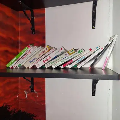 a shelf with a bunch of books on it at دوبلكس في مراكش in Marrakech