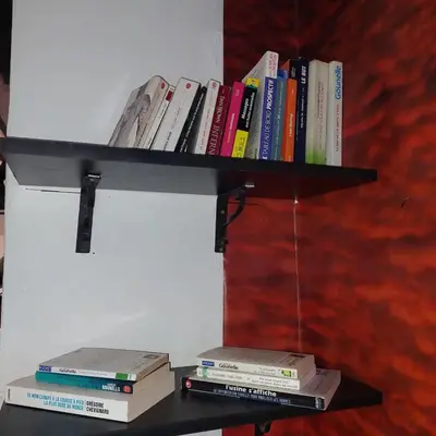 a shelf with books sitting on top at دوبلكس في مراكش in Marrakech