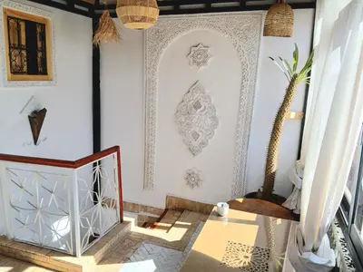 a living room with white walls and a table at Douria FARAH, Authentique in Marrakech