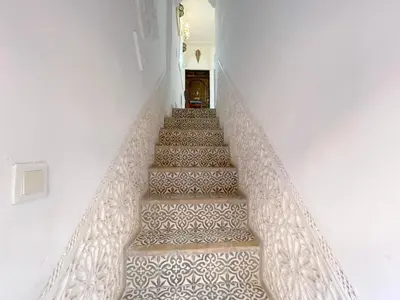 a staircase with a patterned floor in a house at Douria FARAH, Authentique in Marrakech
