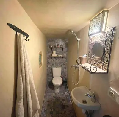 a small bathroom with a toilet and a sink at Douria FARAH, Authentique in Marrakech