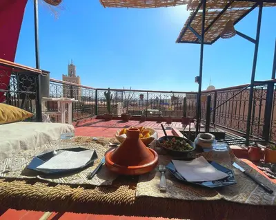 a table with a tea pot on top of a balcony at Douria FARAH, Authentique in Marrakech