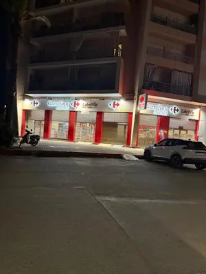 a car parked in front of a store at night at appartement Holiday relais près musée Saint-Laurent in Marrakech