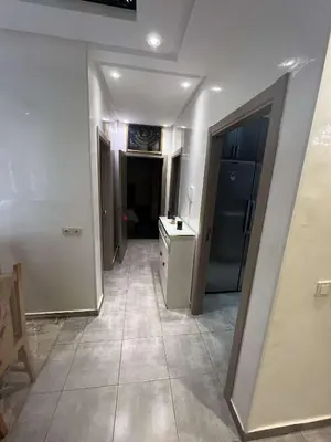 a hallway of a room with a kitchen and a sink at Porte de Marrakech appartement familial avec jardin in Douar Bellouk