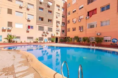 a swimming pool in the courtyard of a apartment building at Grand Appartement Piscine Guéliz in Marrakech