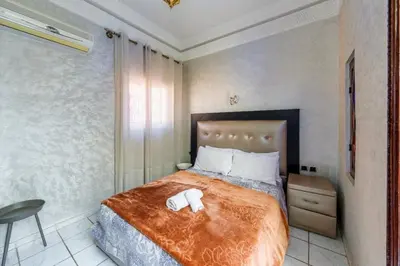 a bedroom with a bed with two towels on it at Riad Malika in Marrakech