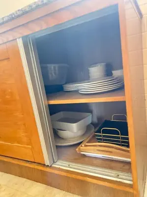 a cabinet filled with plates and utensils at New nice apartment city center swimming pool wifi in Marrakech